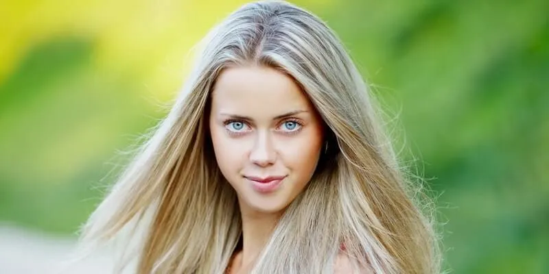 Russian woman with light blue eyes and ash-blonde hair, representing common hair and eye color traits in Russian women